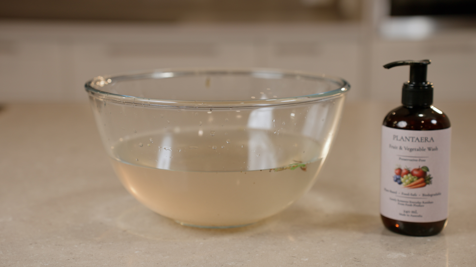 A bowl of cloudy yellow water after washing produce