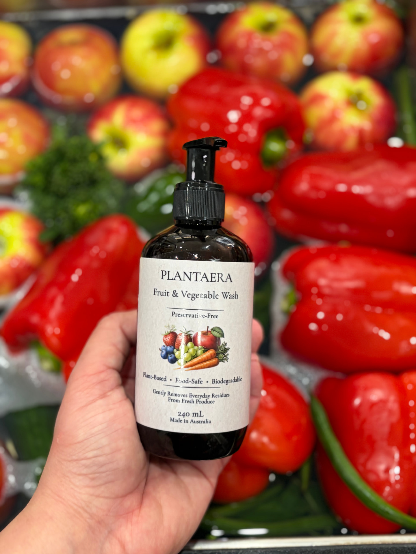 Freshly washed produce arranged on a kitchen counter with a Plantaera bottle